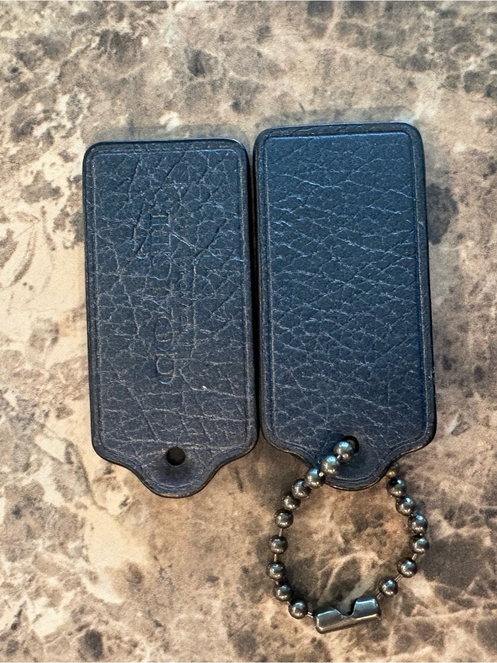 COACH set of 2 metallic navy bag tags
